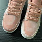 Air Jordan 1 Low pink suede sneakers, front toe and lace detail