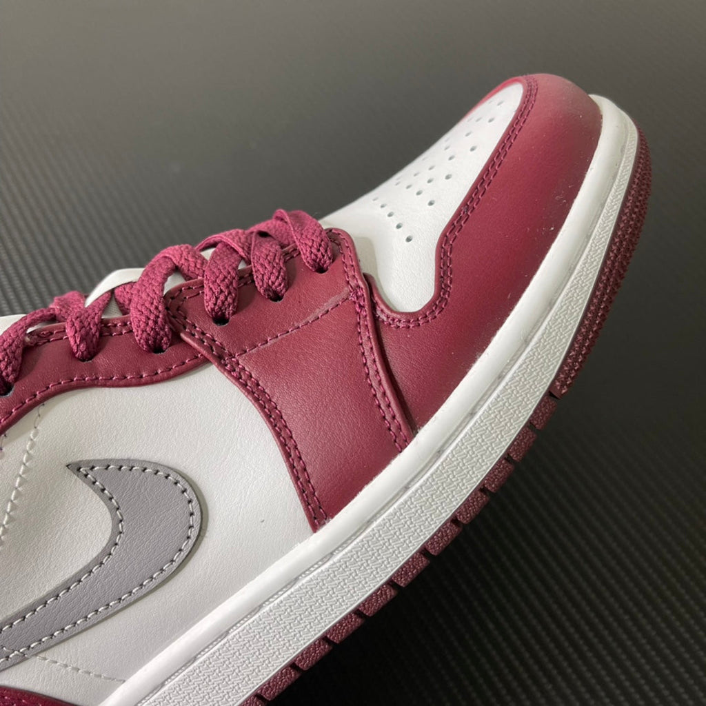 Bordeaux and white low-top sneakers with gray stitched swoosh and lace detail