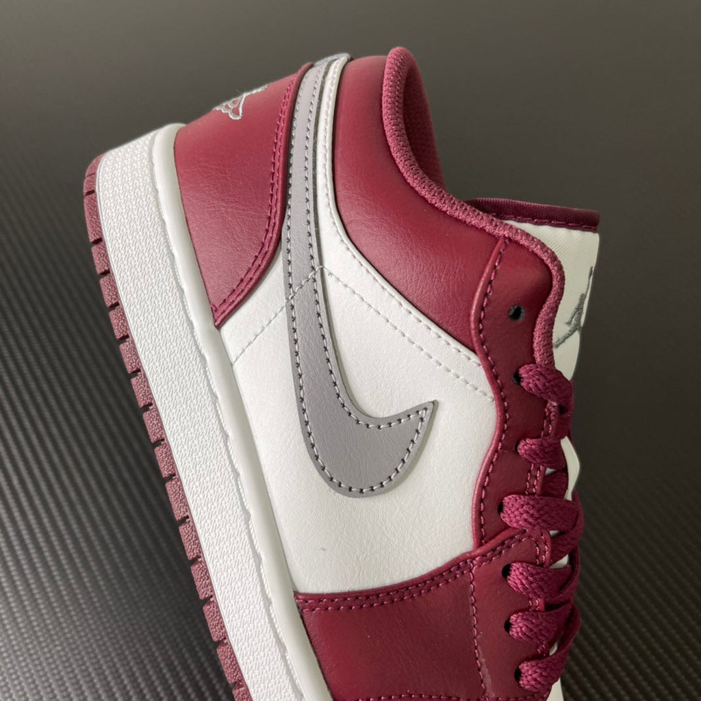 Bordeaux and white low-top sneakers with side panels, gray swoosh, and red laces