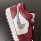 Bordeaux and white low-top sneakers with side panels, gray swoosh, and red laces