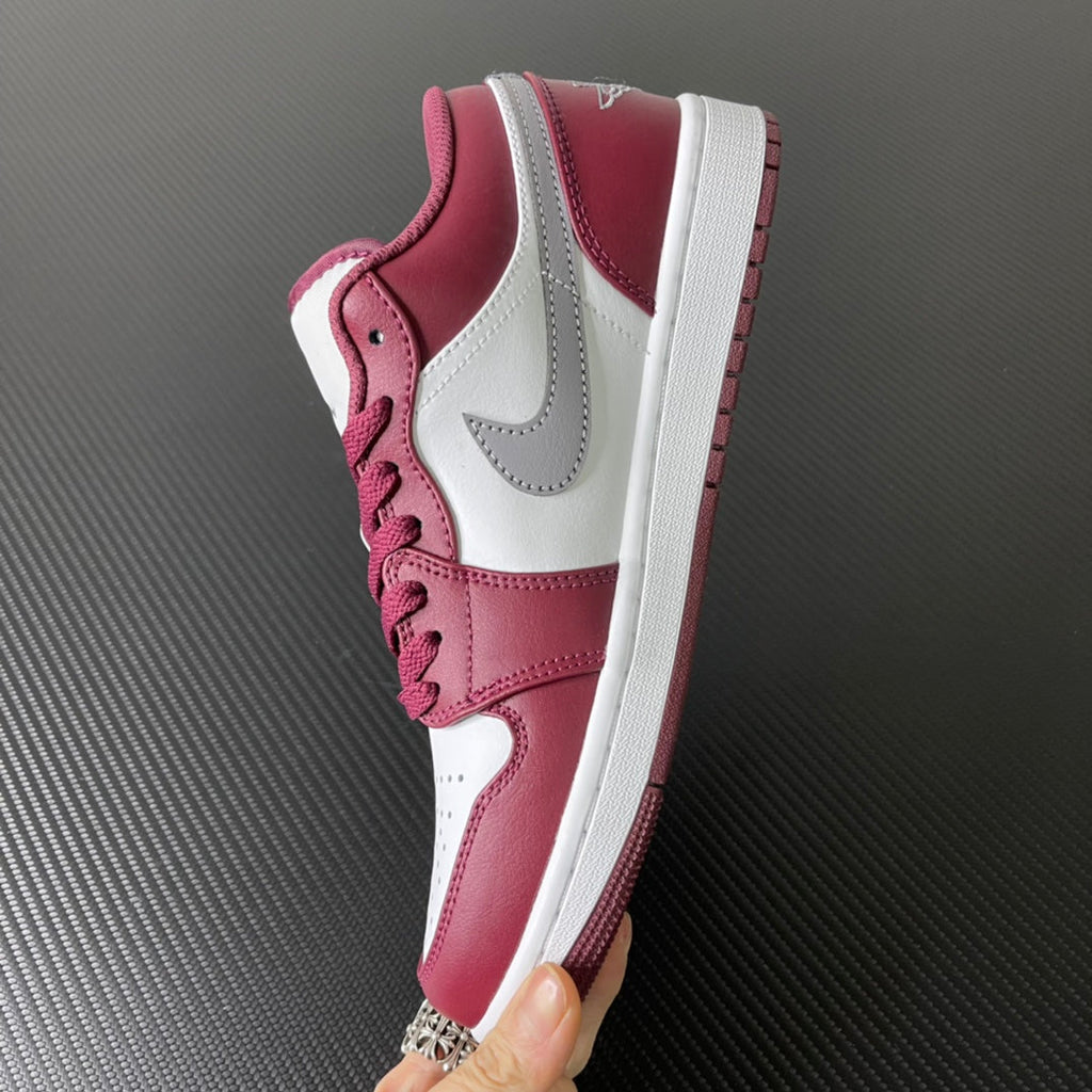 Bordeaux and white low-top sneakers with padded collar, gray swoosh, and lace-up