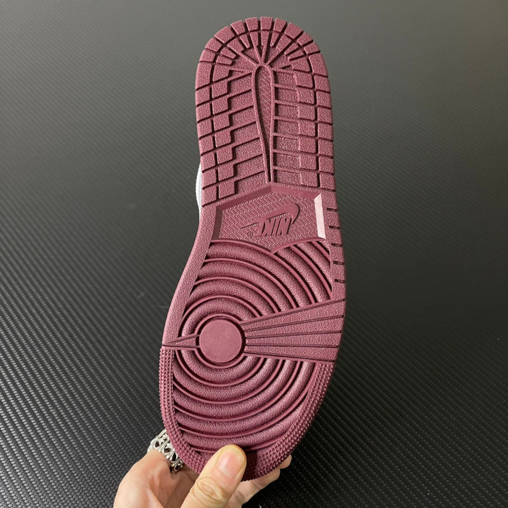 Bordeaux rubber outsole with circular traction pattern and herringbone tread
