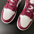 Pair of bordeaux and white low-top sneakers with perforated toe and lace-up front