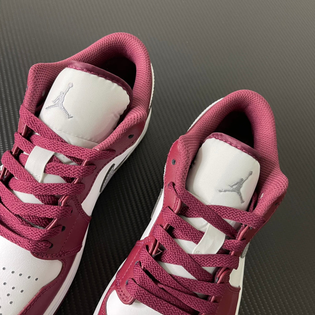 Bordeaux and white low-top sneakers showing tongue logo and lace-up vamp