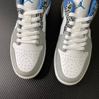 Pair of white low-top sneakers with perforated toe and blue interior lining