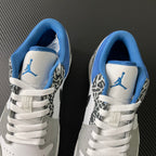 Pair of low-top sneakers with blue lining and Jumpman logo on the tongue