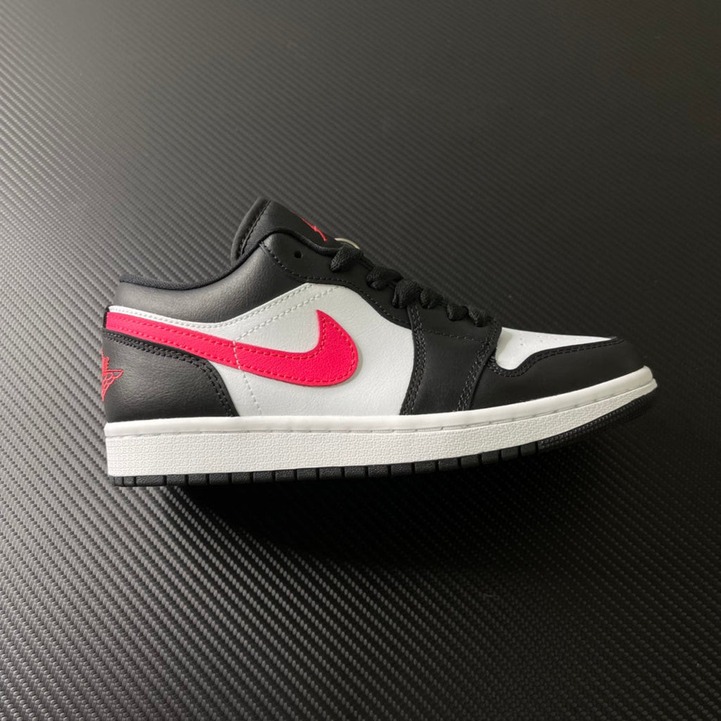 Black and white low-top sneakers with red swoosh and pink side stripe