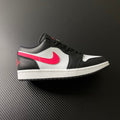 Black and white low-top sneakers with red swoosh and pink side stripe