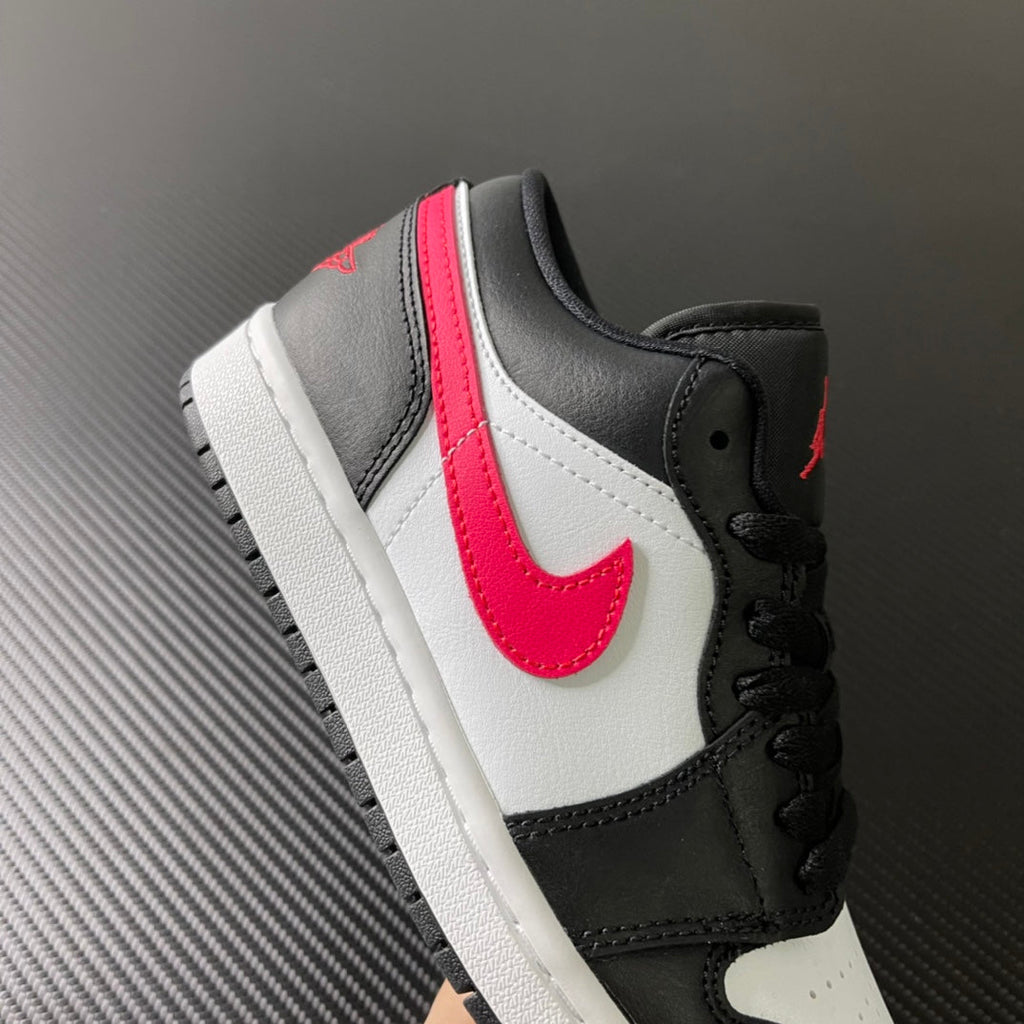 Black and white low-top sneakers with red swoosh and padded black collar