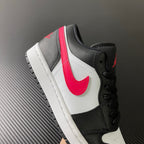 Black and white low-top sneakers with red swoosh and padded black collar