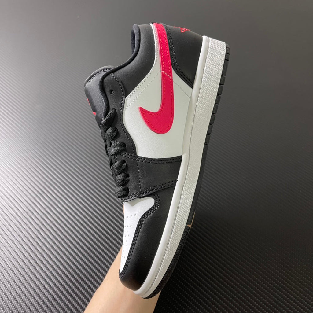 Black and white low-top sneakers with red swoosh and black laces