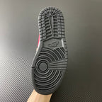 Rubber outsole for black and white low-top sneakers with red accent