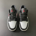 Pair of black and white low-top sneakers with red Air Jordan logos