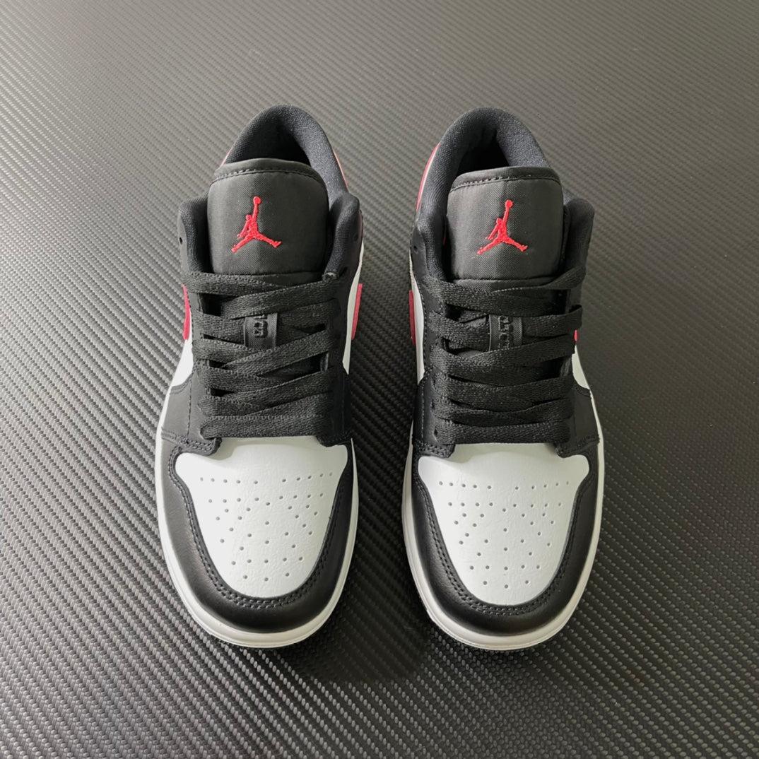 Pair of black and white low-top sneakers with red Air Jordan logos