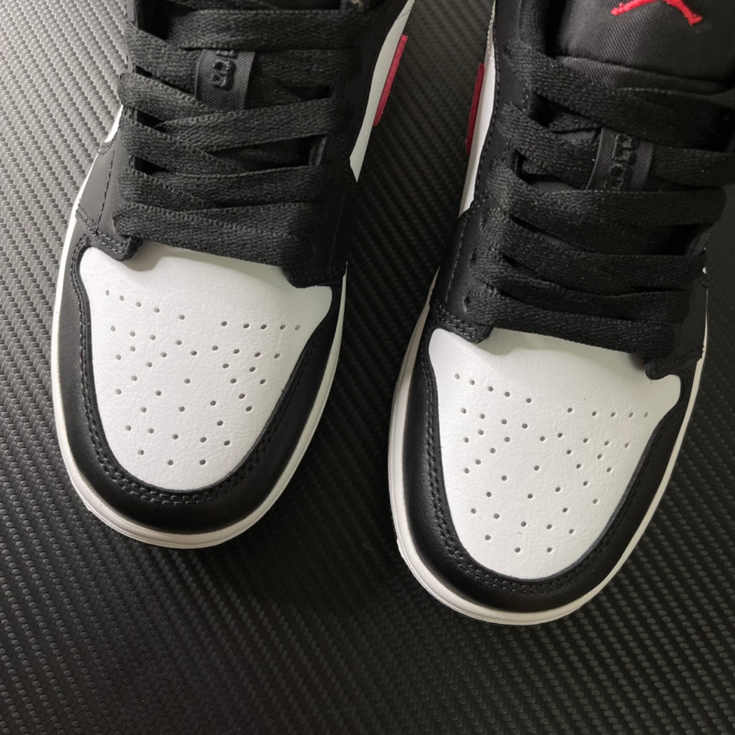 Black laced low-top sneakers with white toe box and perforations