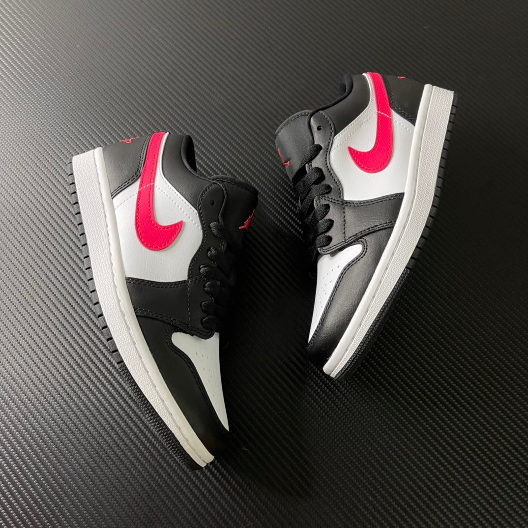 Two black and white low-top sneakers with red swooshes and side panels