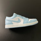 Light blue and cream low-top sneakers with swoosh and lace-up