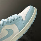 Light blue and cream low-top sneakers, close-up of laces and swoosh