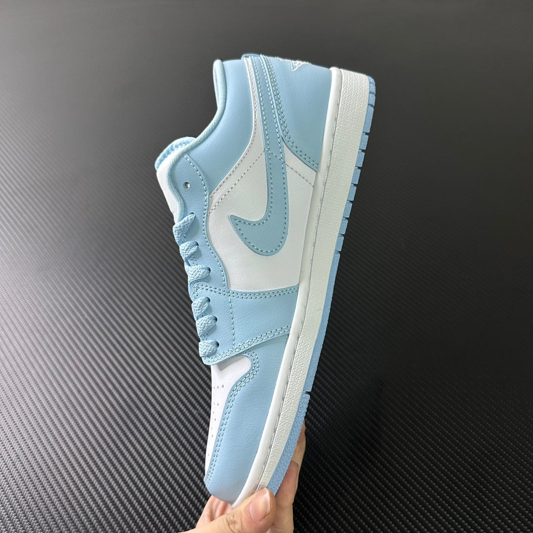 Light blue and cream low-top sneakers, side view with swoosh and laces