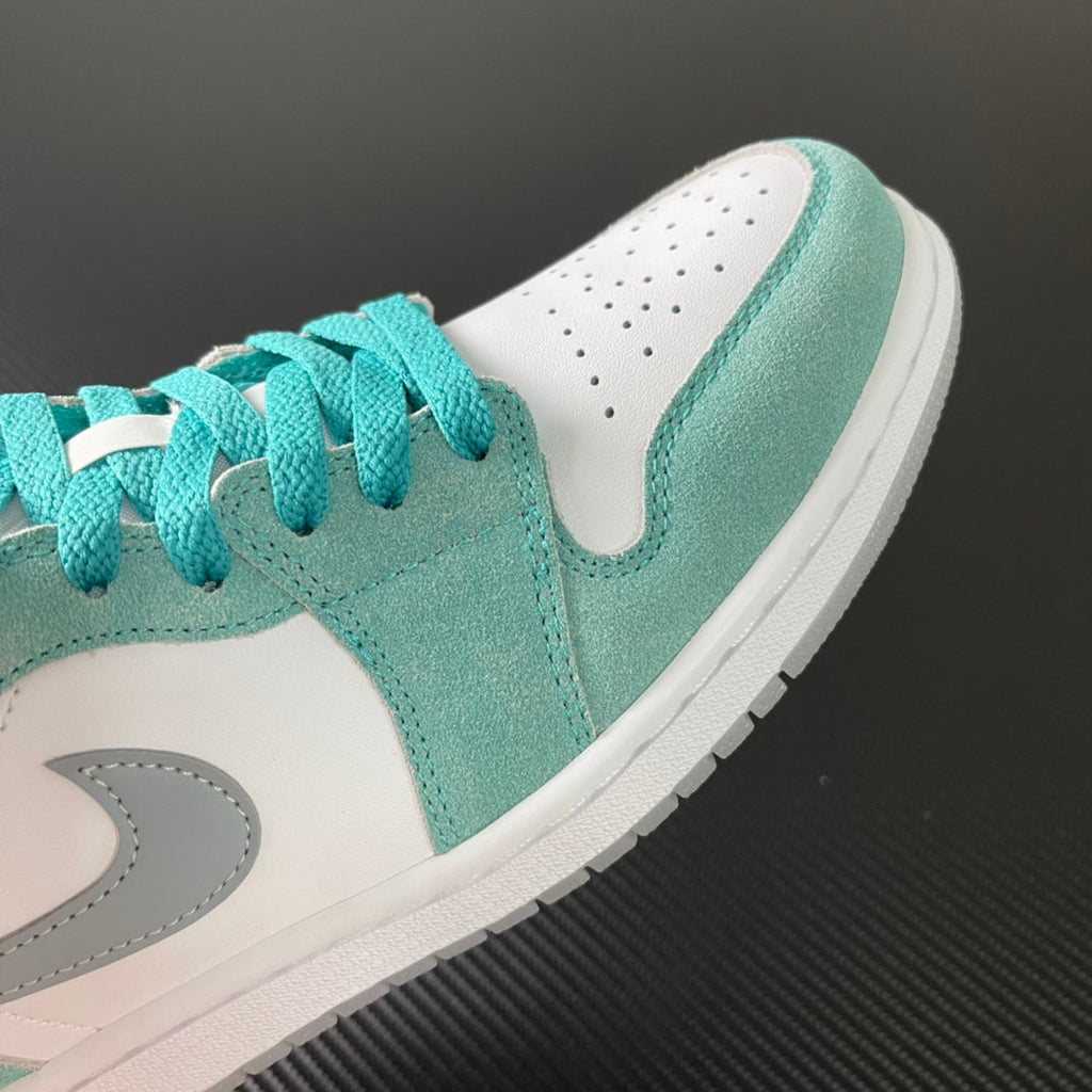 Air Jordan 1 Low sneaker toe area in teal suede with white panel and laces
