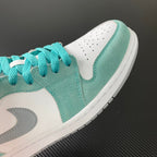 Air Jordan 1 Low sneaker toe area in teal suede with white panel and laces