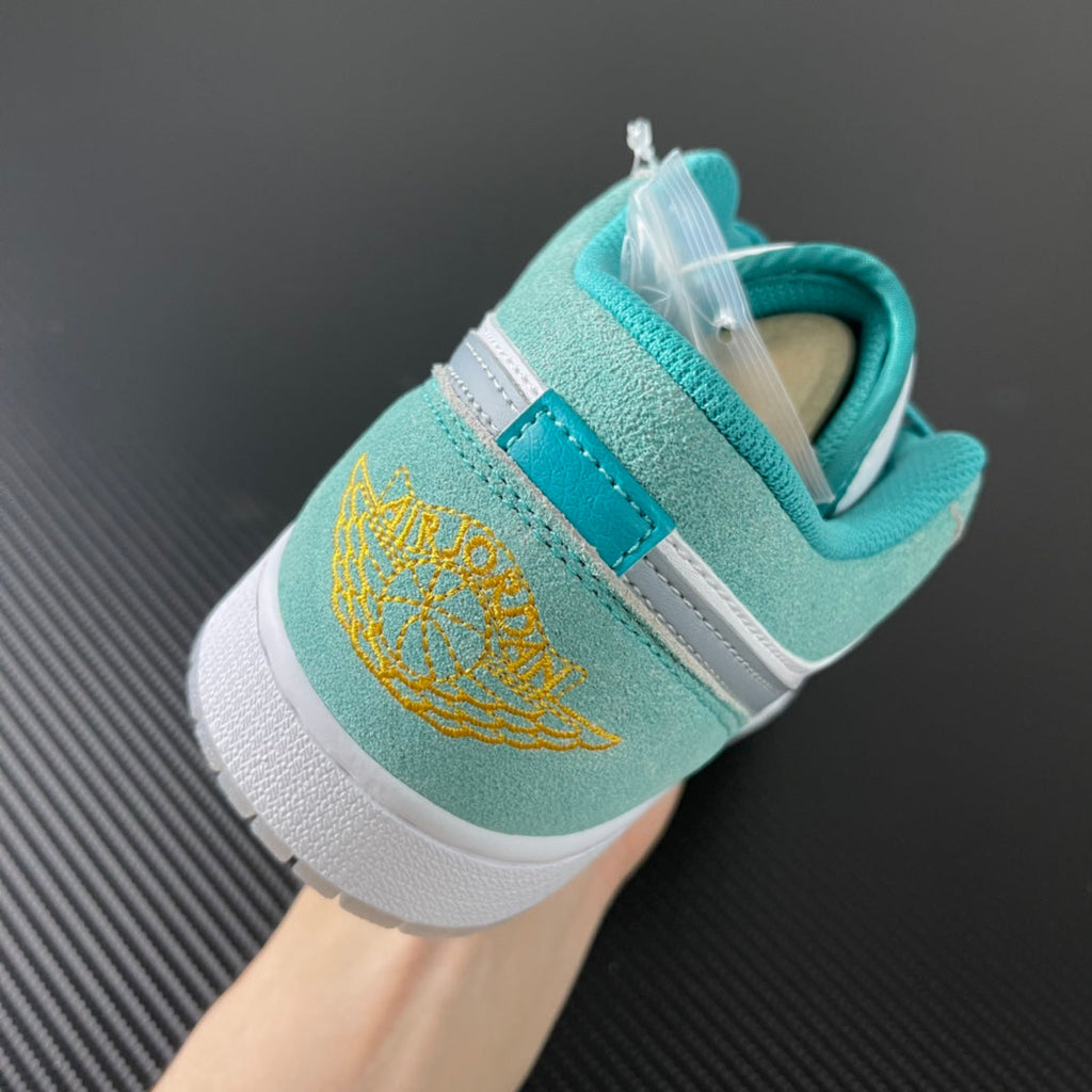 Air Jordan 1 Low sneaker heel in teal suede with white strap and lace-up closure