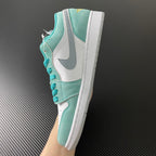 Air Jordan 1 Low sneaker quarter view in teal suede with white panels and teal laces