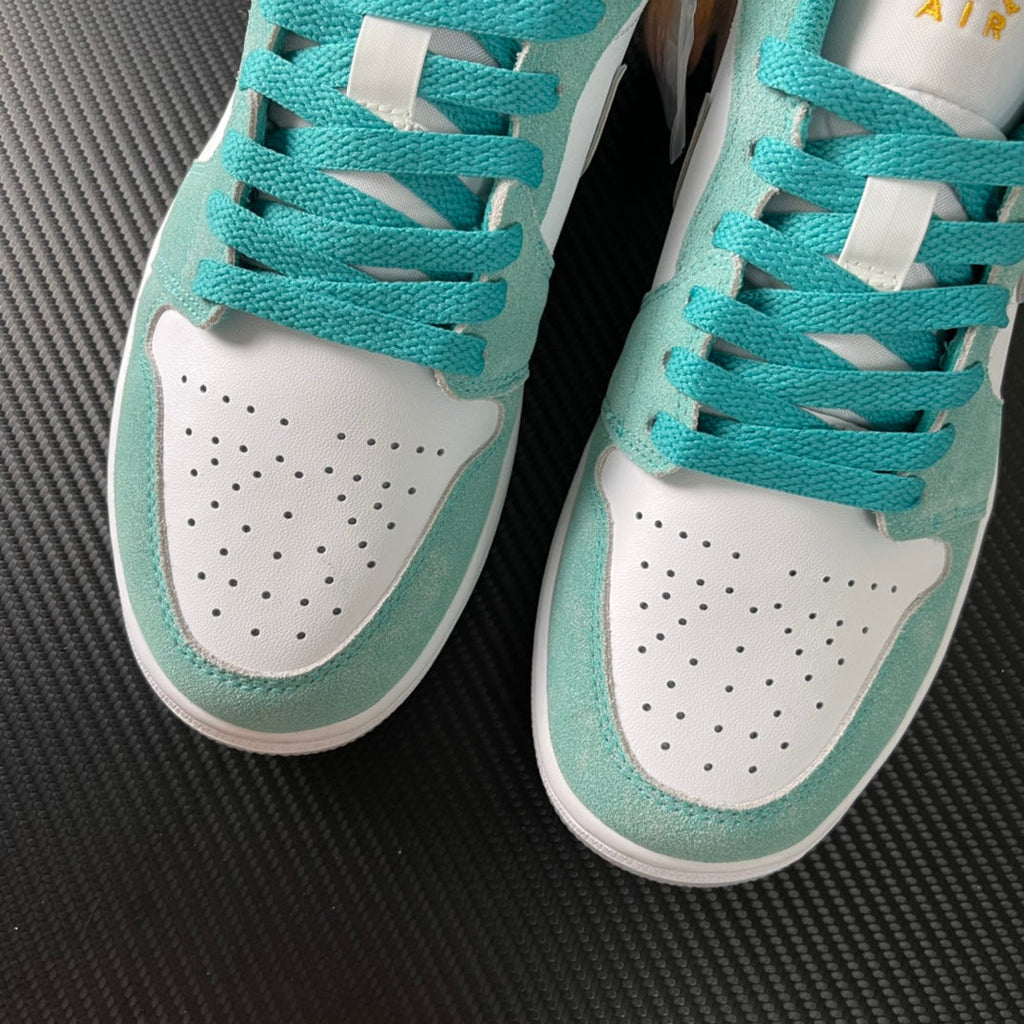 Air Jordan 1 Low sneakers in teal and white with perforated toe and lace panels