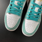 Air Jordan 1 Low sneakers in teal and white with perforated toe and lace panels