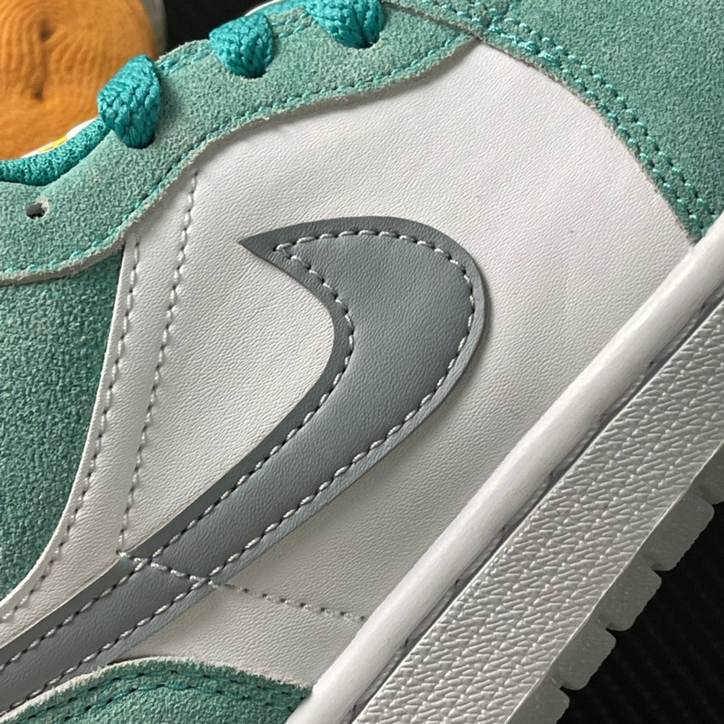 Air Jordan 1 Low sneaker side swoosh detail in gray on white with teal trim