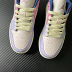 Two low-top sneakers front view, cream toe and lilac overlays with lime-green laces