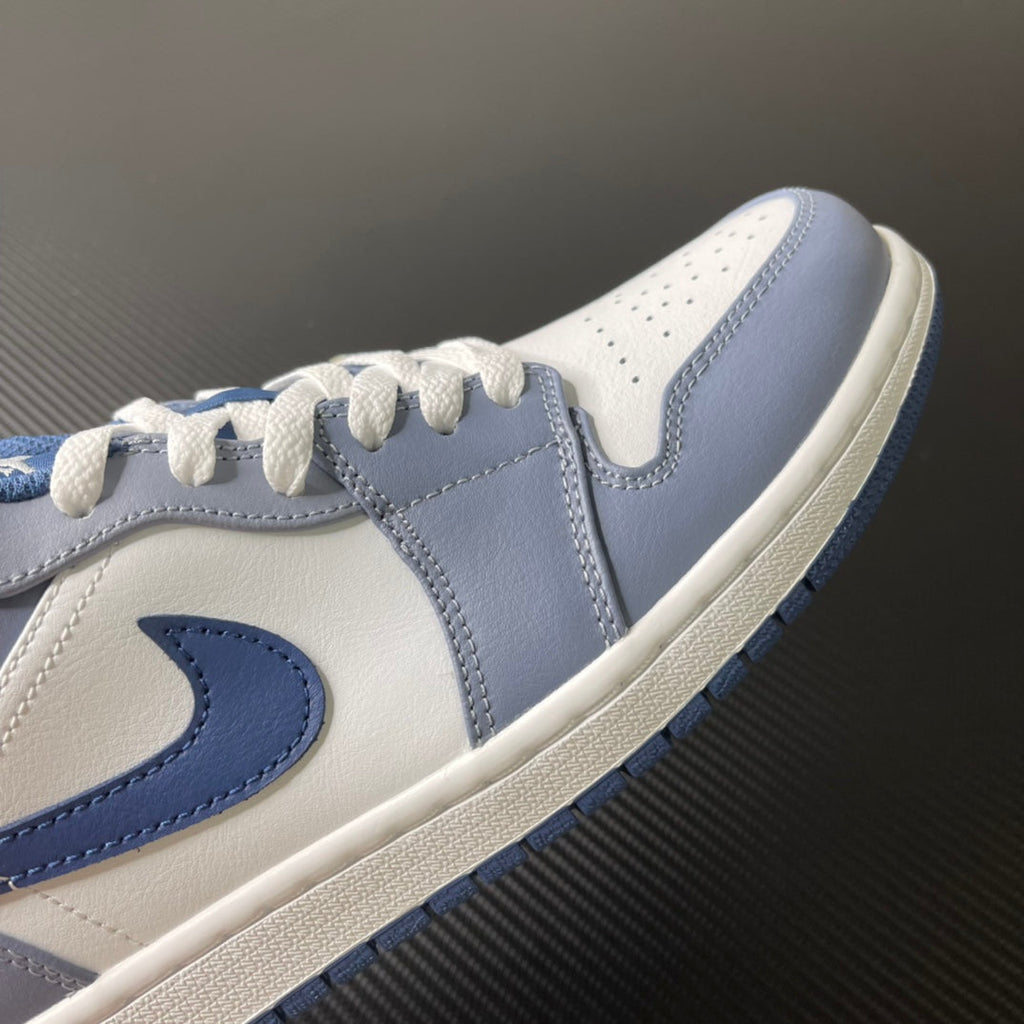 Low-top sneakers side view with light blue swoosh and white leather panels
