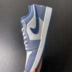 Low-top sneakers angled side view with light blue overlays and white midsoles