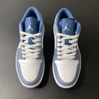 Pair of low-top sneakers in light blue and white with lace-up design and heel logo