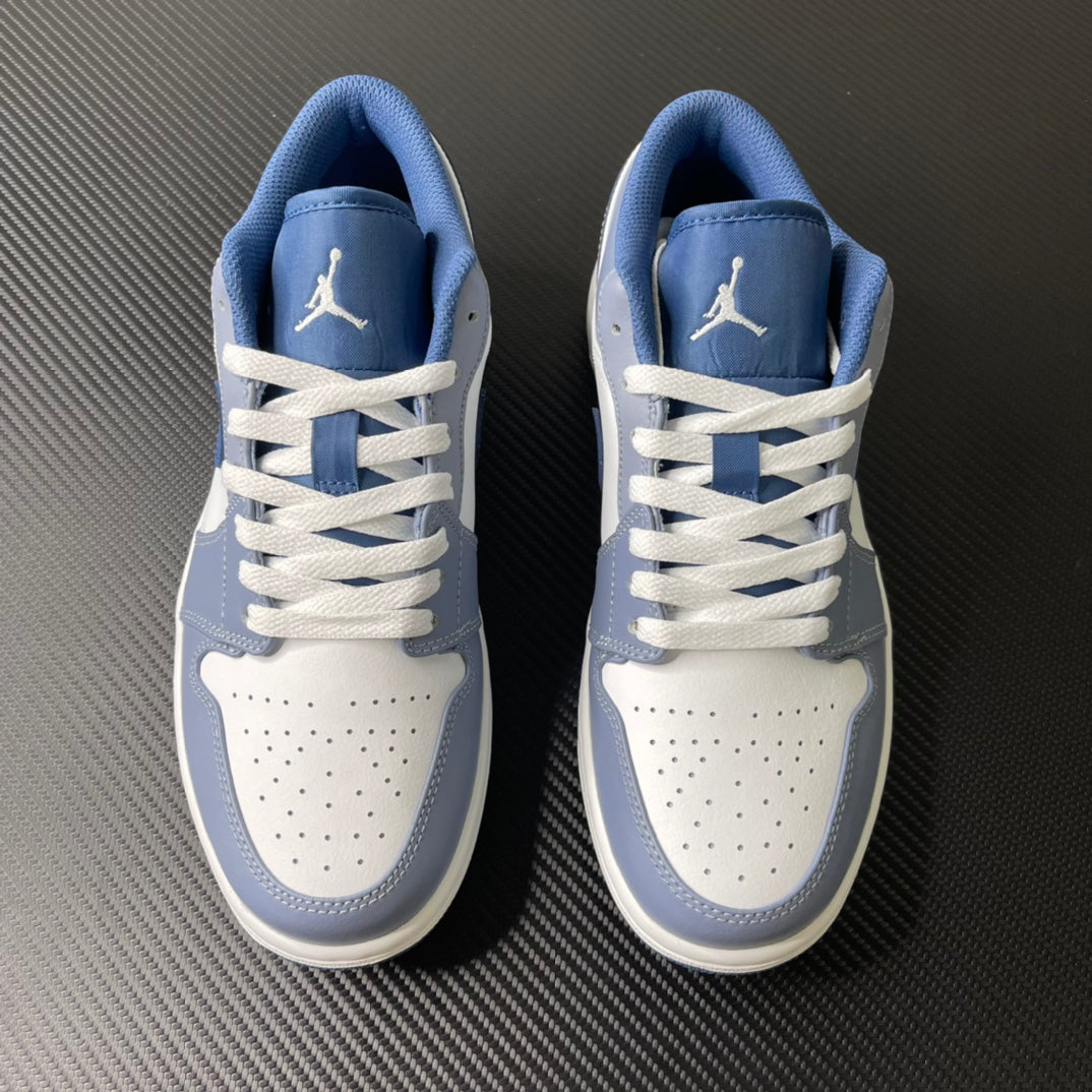 Pair of low-top sneakers in light blue and white with lace-up design and heel logo