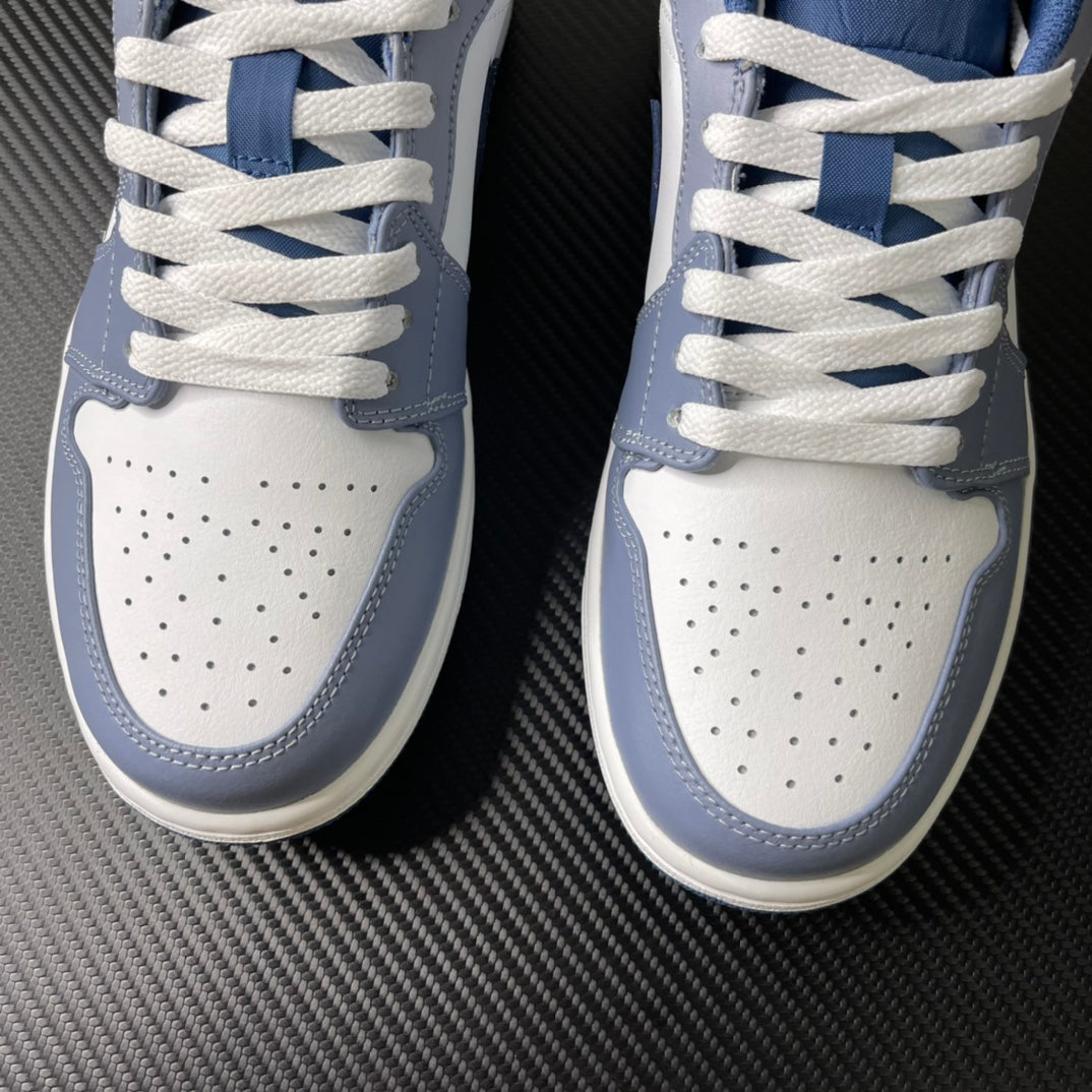 Low-top sneakers top view with white perforated toe, blue panels, and woven laces