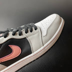 Low-top Air Jordan 1 toe and side view, white leather with black panel and pink Swoosh