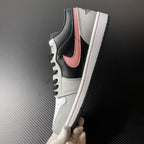 Low-top Air Jordan 1 side view, black and white leather with pink Swoosh