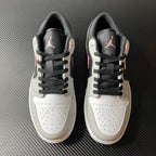 Pair of low-top Air Jordan 1 sneakers, white uppers with black laces and gray heel