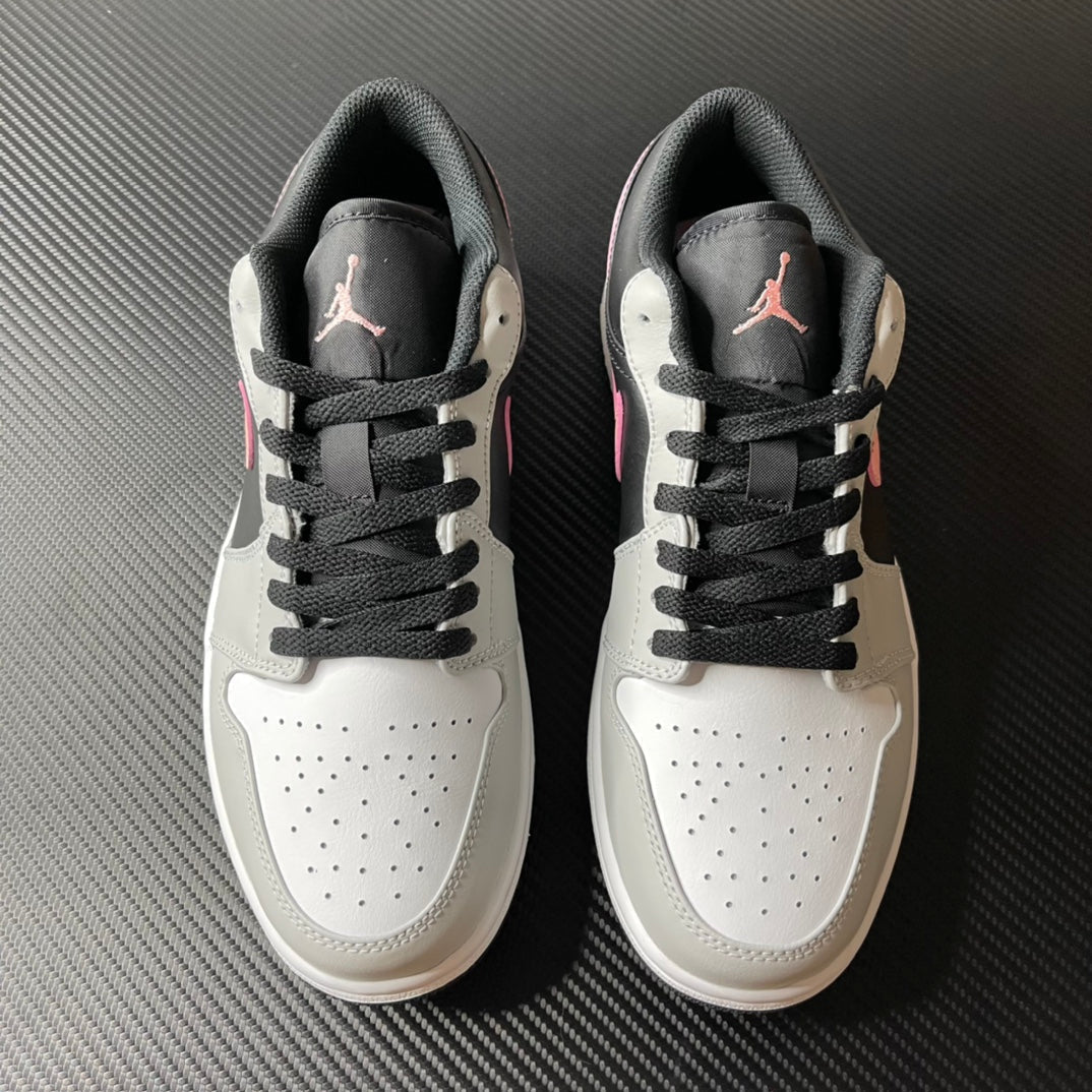 Pair of low-top Air Jordan 1 sneakers, white uppers with black laces and gray heel