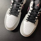 Pair of low-top Air Jordan 1 sneakers, white leather with black laces and perforated toe
