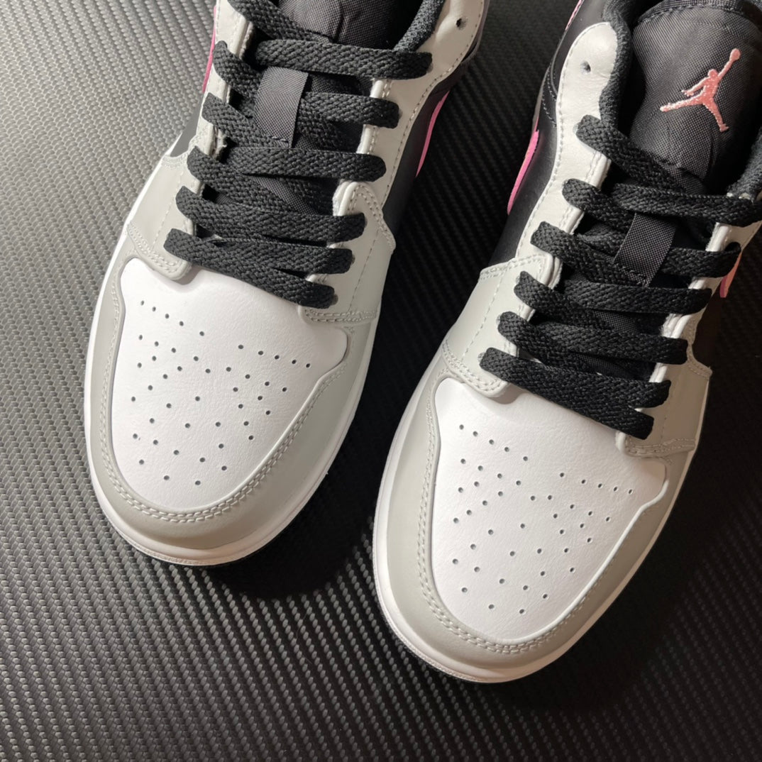 Pair of low-top Air Jordan 1 sneakers, white leather with black laces and perforated toe