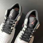 Pair of low-top Air Jordan 1 sneakers, black tongue with pink Jumpman and white sides