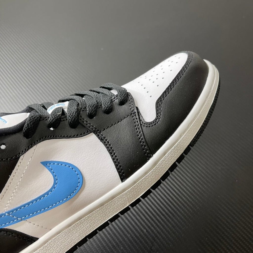 Close-up of low-top sneakers: black and white leather with light blue Swoosh detail.