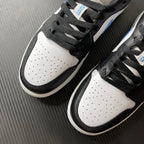 Pair of low-top sneakers on their sides: white perforated toe, black overlays, light blue accents.