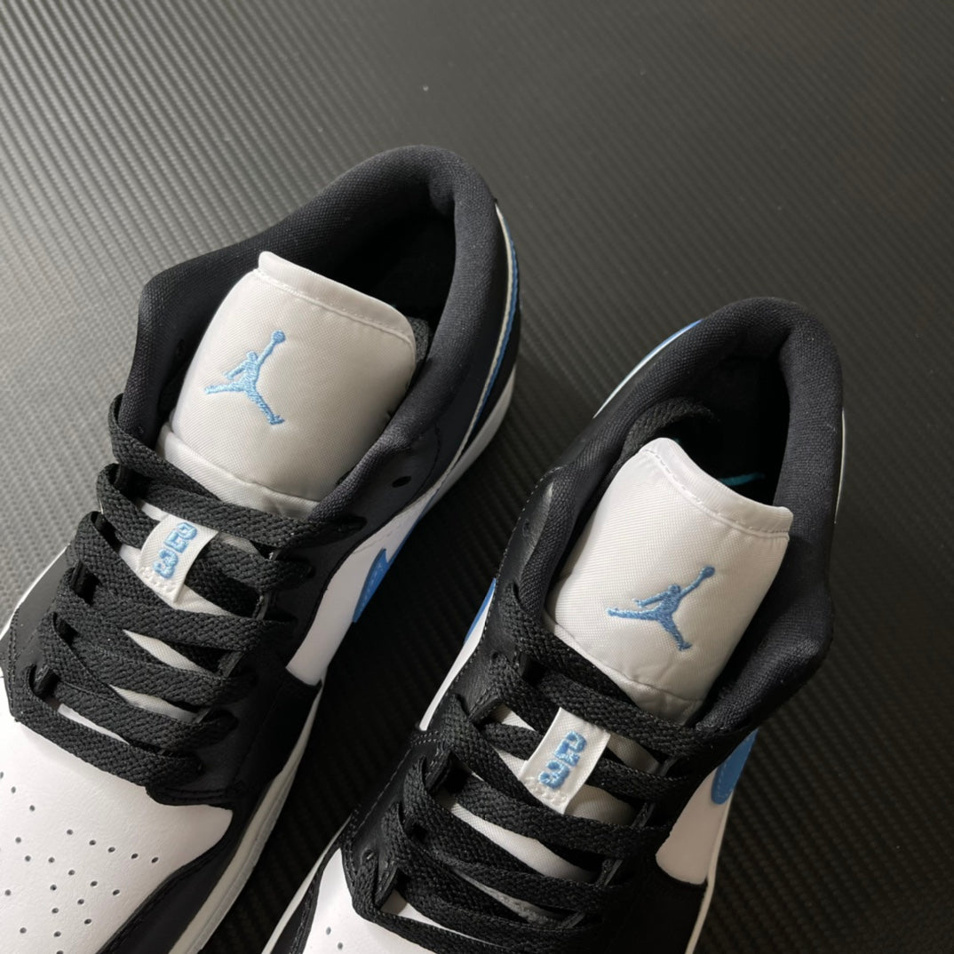 Pair of low-top sneakers showing tongues and heel counters with black laces and light blue Jumpman.
