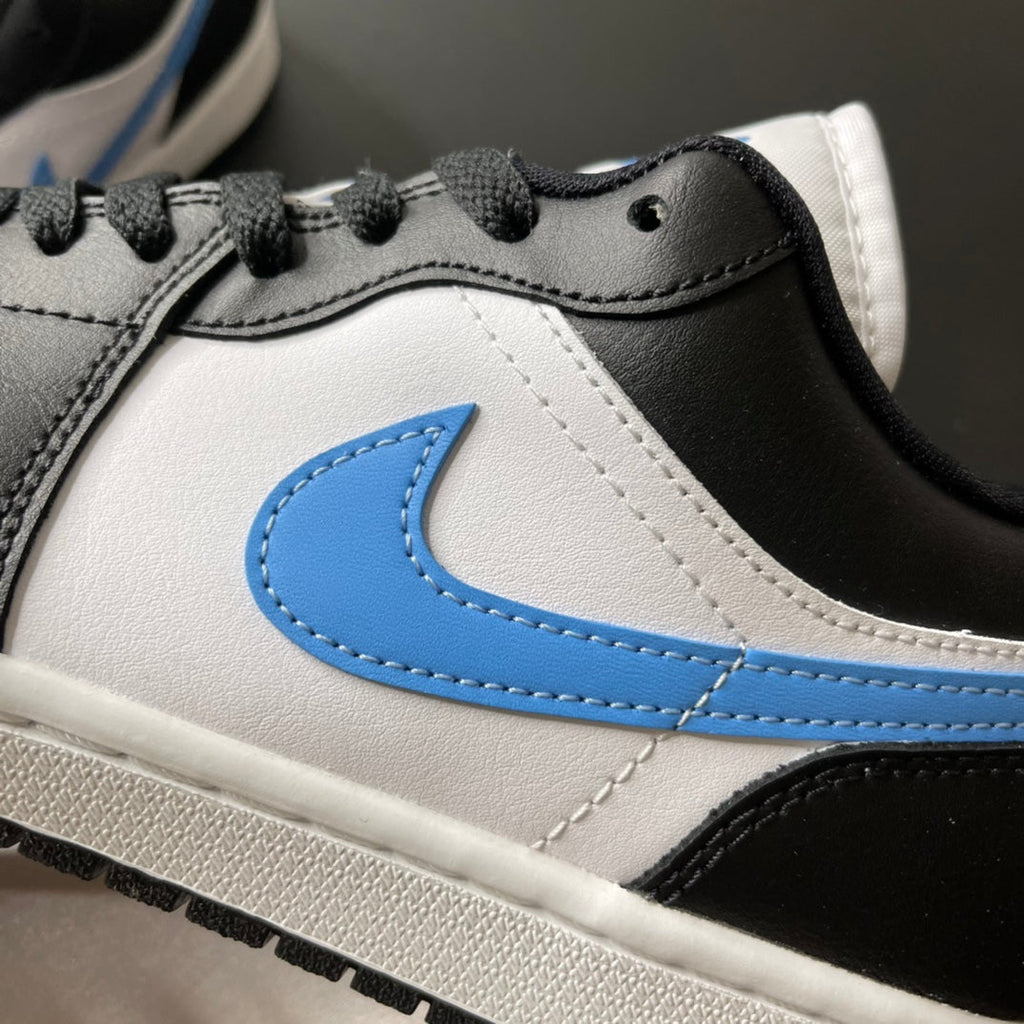 Close-up of low-top sneaker upper with light blue Swoosh and black-and-white stitching.