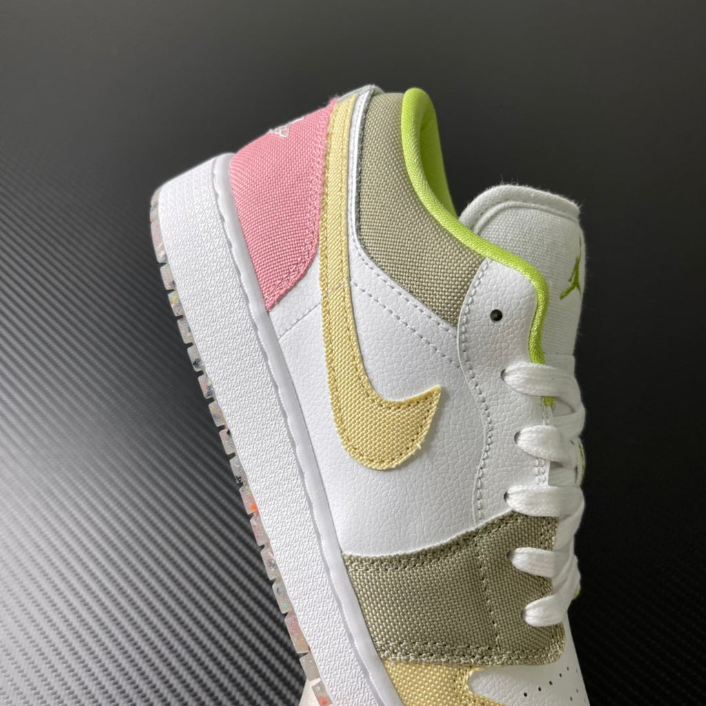 Low-top sneaker side view in white with pink, olive and yellow overlays