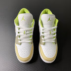 Pair of low-top sneakers in white with neon green collars and gold toe panels