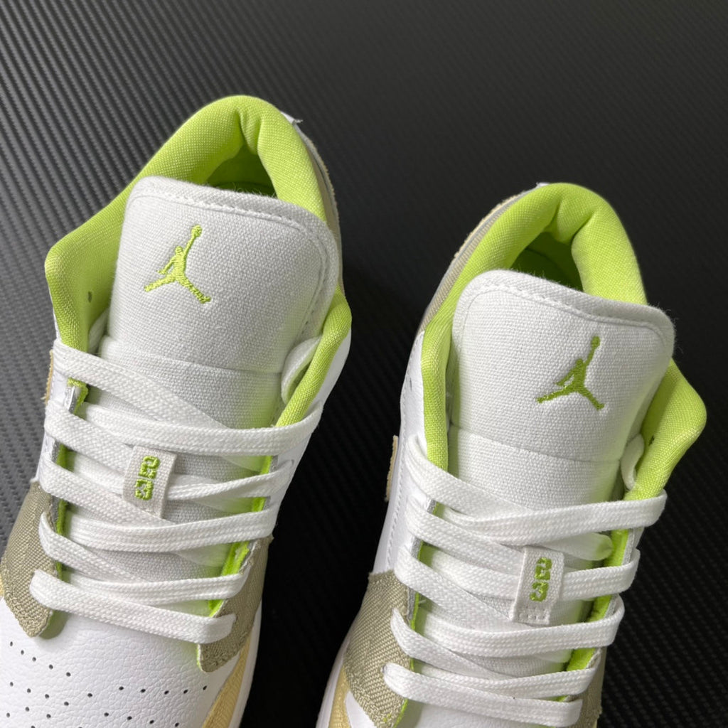 Pair of low-top sneakers with white heel panels and neon green interior